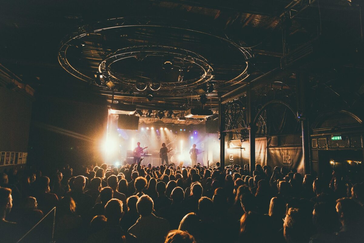 people attending concert inside dark room